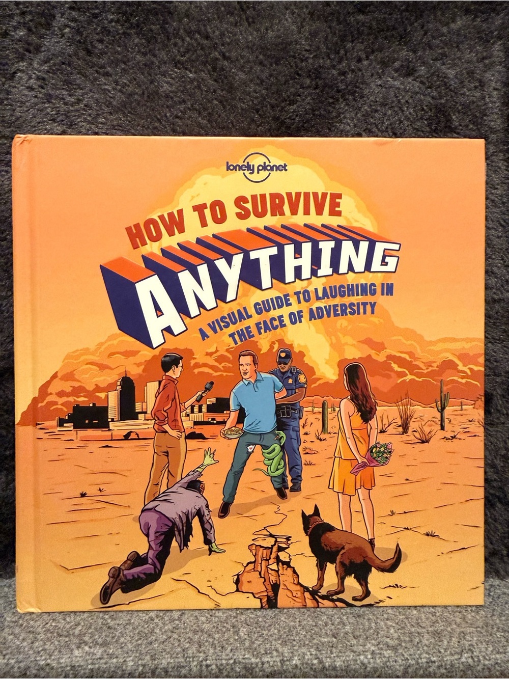 Lonely Planet "How to Survive Anything" Orange Hardcover Book